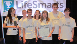 4-H students and their advisor wear LifeSmarts t-shirts