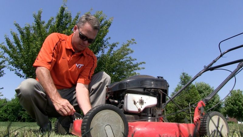 Shawn Askew, Extension Turfgrass Weed Specialist at Virginia Tech, adjust a blade on a lawn mower to help homeowners properly mow their lawns. 